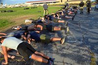 Twenty-five future sailors try to complete as many push-ups as possible in two minutes.