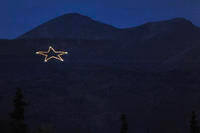 Joint Base Elmendorf-Richardson star is Illuminated on the side of Mount Gordon Lyon