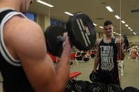 A seaman executes biceps curls.