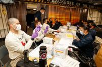 Sailors prepare COVID-19 vaccine booster shots aboard USS Abraham Lincoln