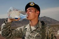 An airman drinks water in front of Nellis Air Force Base, Nevada.