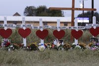 crosses for members of the Holcombe family are part of a makeshift memorial 