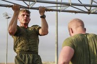 A Marine does pull-ups during unit physical training at Camp Lemonnier, Djibouti.