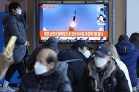 People watch a TV showing image of North Korea's missile launch.