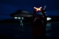 A crew chief prepares to marshal a B-1B Lancer at RAF Fairford, United Kingdom.