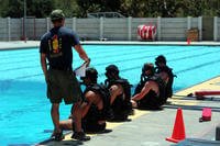 Navy special amphibious reconnaissance corpsmen prepare to enter the pool for a proficiency training dive.