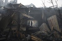 Firefighters work to extinguish a fire at a house after a Russian attack in Kharkiv, Ukraine.