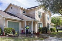 A maintenance worker for Balfour Beatty Housing power-washes a driveway in a military residential community at Naval Station Mayport, Florida.