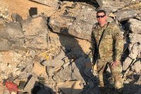 Staff Sgt. Aaron Futrell, of the Ohio National Guard, stands in rubble following a missile barrage from Iran.