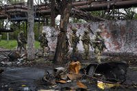 Russian troops walk in a destroyed part of the Illich Iron &amp; Steel Works Metallurgical Plant in Mariupol, in territory under the government of the Donetsk People's Republic, eastern Ukraine.