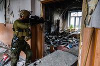 Georgian Legion member surveys the carnage of a destroyed school.