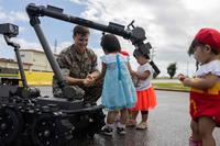 Marines distribute candy at Camp Hansen’s Halloween event.