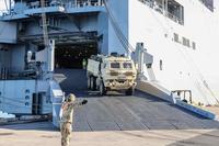 Soldier load vehicles onto U.S. Naval Ship Watson 