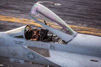 pilot sits in the cockpit of a jet on the flight deck of the USS Gerald R. Ford CVN-78