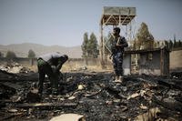 Yemeni police inspect a site of Saudi-led airstrikes.