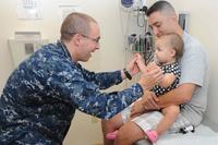 A pediatrician  the motor skills of a baby.