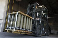 Airmen with the 436th Aerial Port Squadron use a forklift to move 155 mm shells ultimately bound for Ukraine