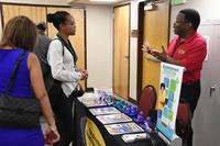 Attendees discuss employment and the job search process with a career counselor at Pope Field at Fort Bragg, N.C.