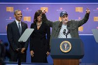 Former ‘Daily Show’ host Jon Stewart tells jokes behind the president’s lectern as President Barack Obama and first lady Michelle Obama look on during the comedy show in celebration of the 75th anniversary of the USO and the fifth anniversary of Joining Forces at Joint Base Andrews in Washington, D.C.