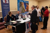 Veterans speak with a training service during a career fair for veterans at the Scottish Rite Center in San Diego.