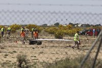 Emergency responders work in the area where an F-18 fighter jet crashed in Spain.
