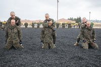 Recruits with Golf Company, 2nd Recruit Training Battalion, execute a figure-four variation during a Marine Corps Martial Arts Program (MCMAP) session at Marine Corps Recruit Depot San Diego.