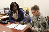 Spc. Mason Steill gets financial assistance from Frederica Norman, a financial adviser at the Soldier and Family Assistance Center on Joint Base Lewis-McChord, Wash.