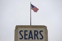 An American flag flies above a Sears department store sign in Hackensack, N.J. 