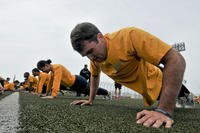 Sailors aboard the aircraft carrier USS George Washington in Yokosuka, Japan, conduct push-ups during a physical readiness test. 