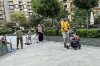 Afghans walk at a tourist resort where they are accommodated, in Shengjin