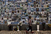 phots of Ukrainian soldiers killed in the county's war against Russia, at the Wall of Remembrance
