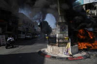 Tires burn during an Israeli military raid.