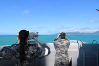  Royal Australian Navy sailors from HMAS Brisbane scan the horizon
