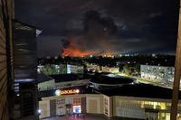  smoke billowing over the city and a large blaze in Pskov, Russia