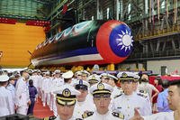 A group of navy personnel pass through Taiwan's domestically-made submarine