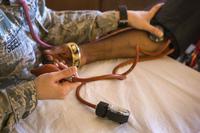 U.S. Air Force medical technician checks a veteran’s blood pressure