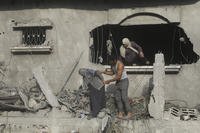 Palestinians evacuate a building.