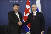 Russian President Vladimir Putin shakes hands with North Korea's leader Kim Jong Un.