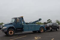 A tow truck drops off an abandoned vehicle in the impound parking lot on Joint Base McGuire-Dix-Lakehurst, New Jersey.