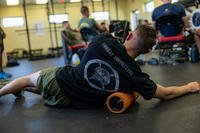 A Marine Corps sergeant uses a foam roller during a foundational movement class on Marine Corps Base Quantico, Virginia.