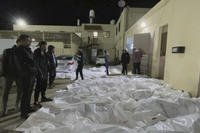 People look over some of the bodies at Al Aqsa hospital in Deir El Balah, Gaza on Dec. 24, 2023.