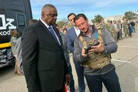 Defense Secretary Lloyd Austin takes a look at a device used to control a swarm of drones.