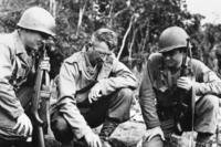 Brig. Gen. Frank Merrill (center), the commander of the Army unit nicknamed ‘Merrill’s Marauders,’ explains the situation to 2 interpreters in Burma in 1944.