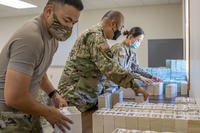 soldiers stack simulated currency after moving their operation