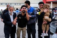 Families of victims of the explosions gather at the courtyard of a hospital in the city of Kerman