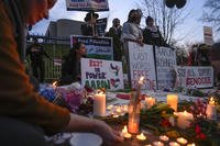 Demonstrators light candles during a vigil outside the Israeli Embassy in Washington.