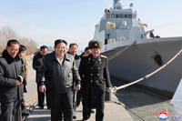 North Korean leader Kim Jong Un, center, visits a shipyard in Nampho, North Korea