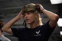 Recruit tries on a helmet during a tour of MacDill Air Force Base
