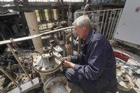 A worker repairs damaged thermal power plant near Kharkiv, Ukraine