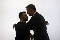 Ukraine's President Volodymyr Zelenskyy, left, is welcomed by Belgium's Prime Minister Alexander De Croo